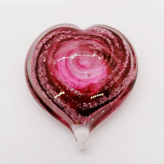 Ashes in red Heart Memorial Paperweight on white background