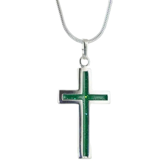 Silver cross pendant on snake chain with green sparkling colour inlay on a white background