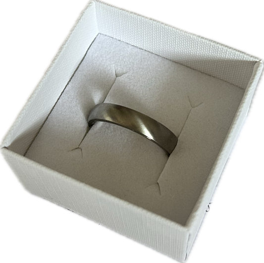 grey ashes plain satin dome ring in a white box on a transparent background