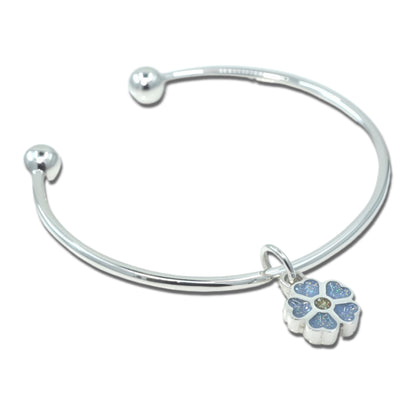 Silver ashes bracelet with a forget me not blue flower charm on a white background