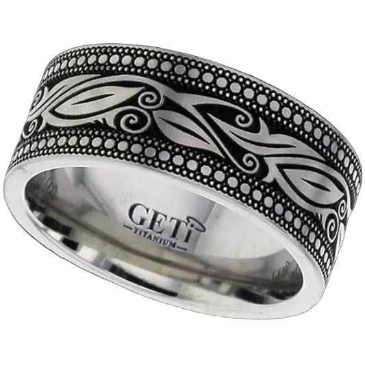 Silver polished titanium ashes ring with intricate leaf designs and circles created by invereted engraving on a white background.