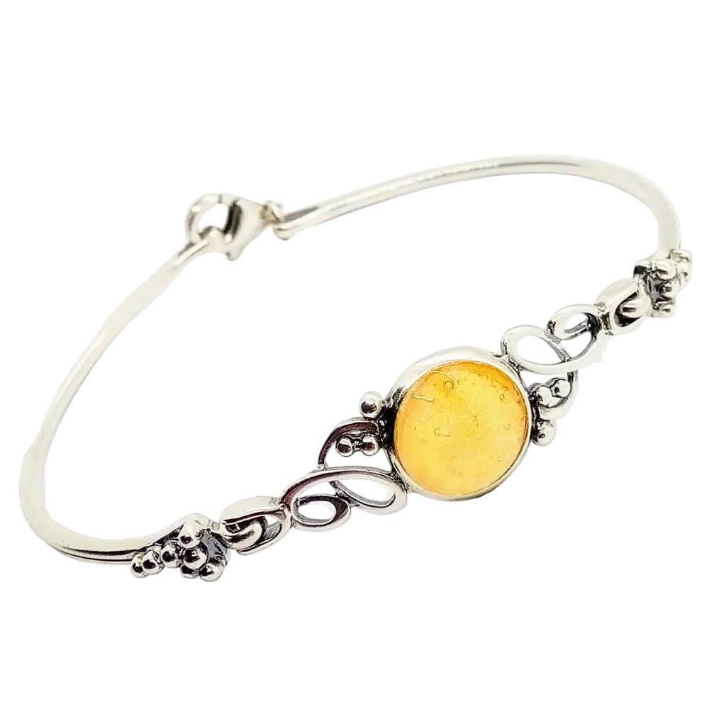 An ornate ashes sterling silver bangle bracelet featuring a yellow glass bead with ashes, on a white background.