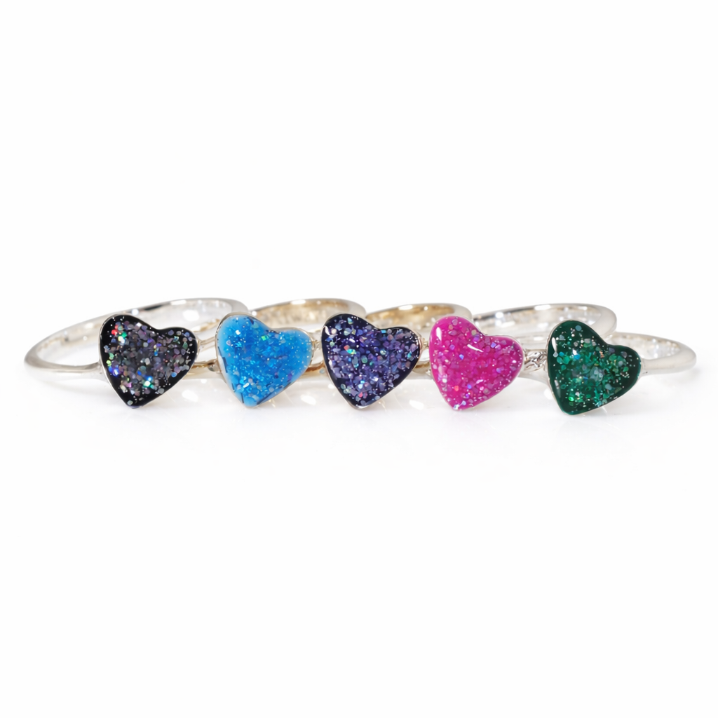 Gold and silver heart rings displayed in multiple glittery stone colours on a white background