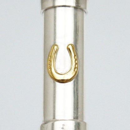 Close up Silver cylindrical urn pendant with a gold shaped horseshoe. 