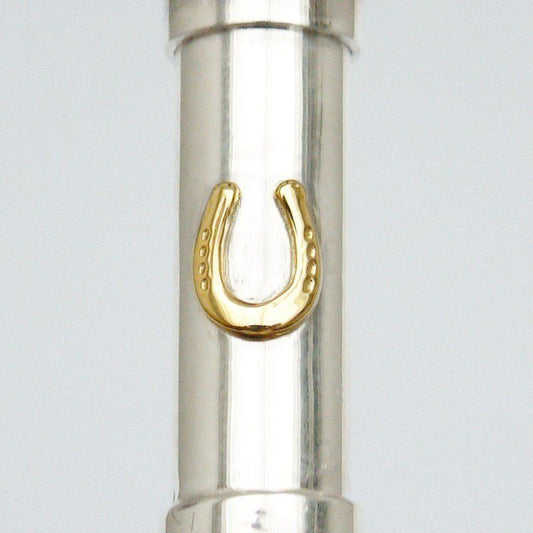 Close up Silver cylindrical urn pendant with a gold shaped horseshoe. 
