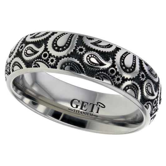 Silver ring with black inverted paisley pattern on a white background
