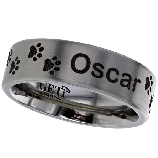 paw print and pet name modern polished ashes titanium ring on a white background