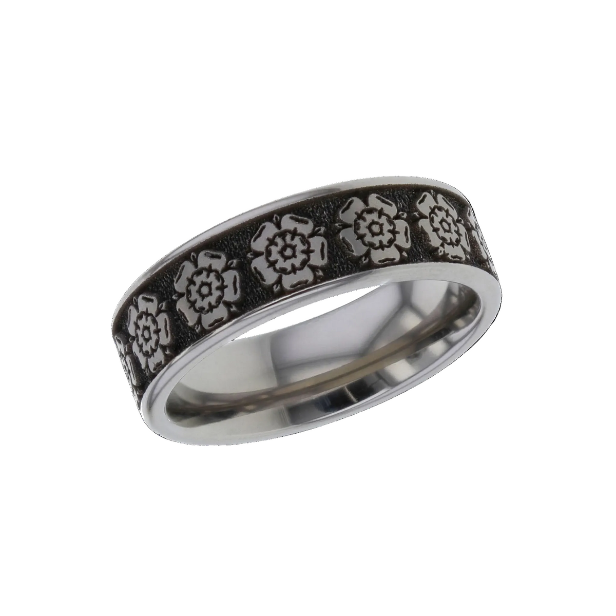 A silver-toned titanium metal band ring for cremation ashes featuring a textured black inlay with embossed floral rose motifs, shown on a plain white background.
