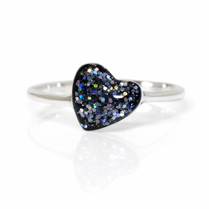 Silver slim ring band with black glittery heart-shaped stone on a white background