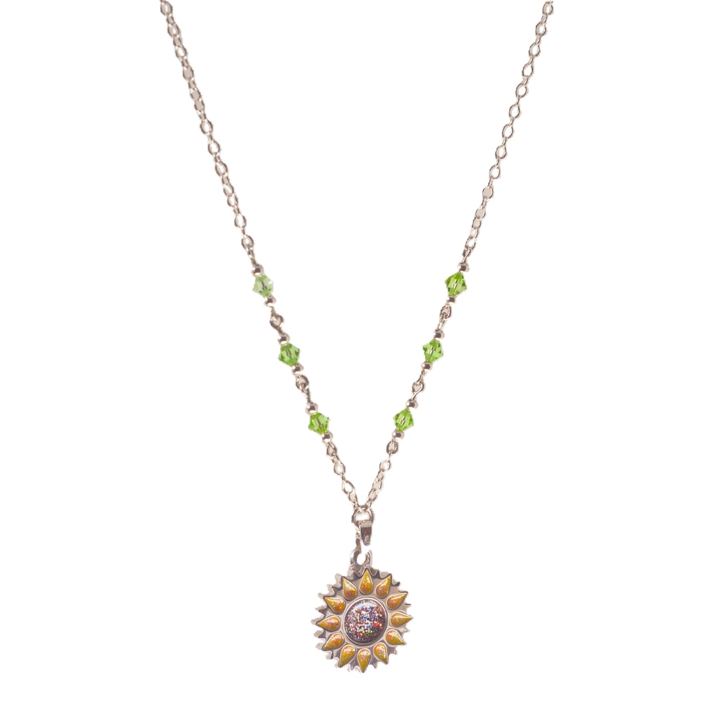 Sunflower pendant with sparkling yellow petals and a round sparkling warm orange centre on a silver long chain with green beads on a white background