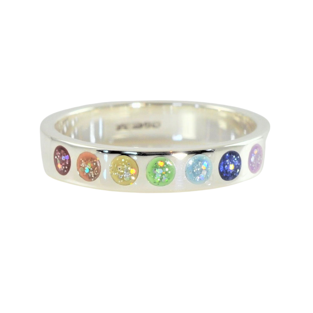 Silver ring band with seven rainbow coloured stones on a white background