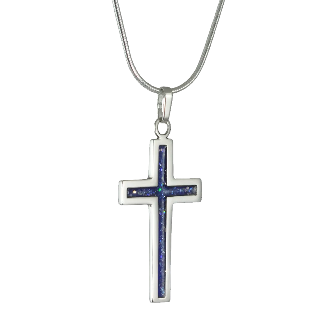 Silver cross pendant on snake chain with blue sparkling colour inlay on a white background