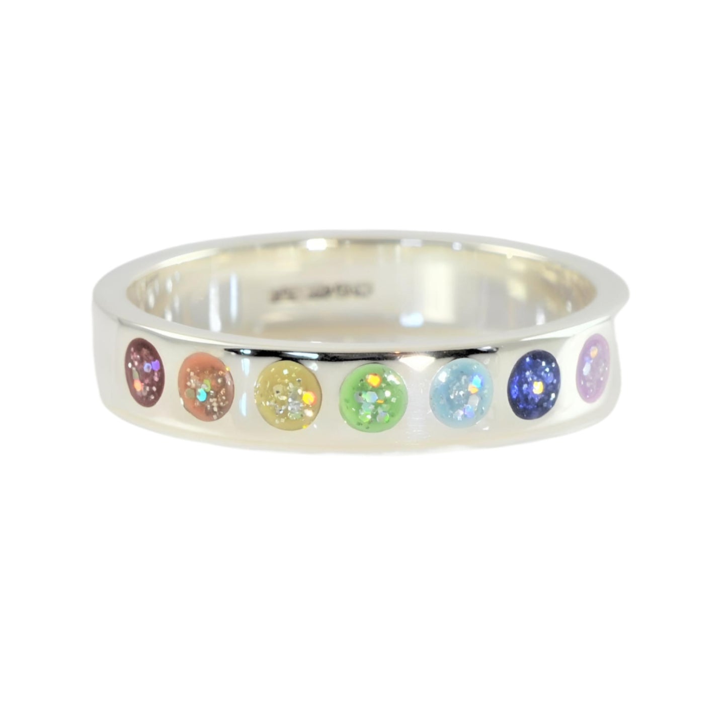 White gold ring for ashes with seven rainbow coloured stones on a white background