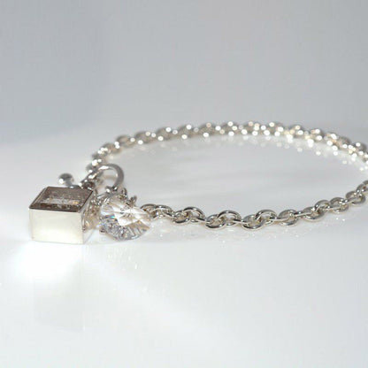 Ashes in Crystal Glass, Corner-Hung Charm.